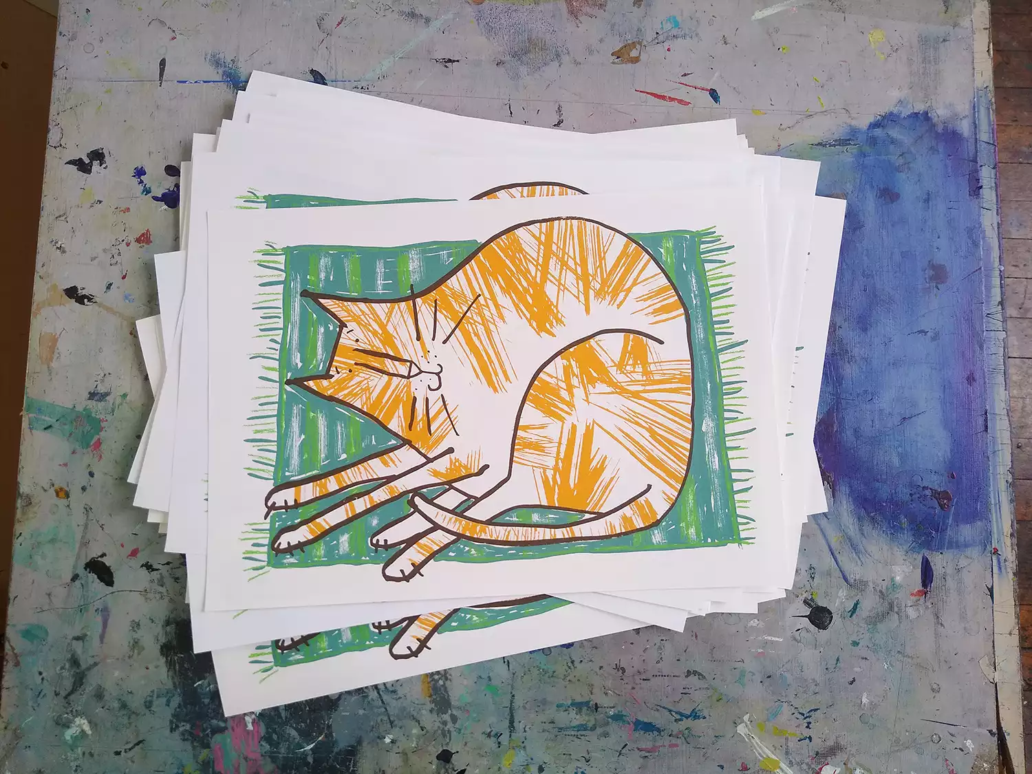 orange and white tabby cat on green mat prints