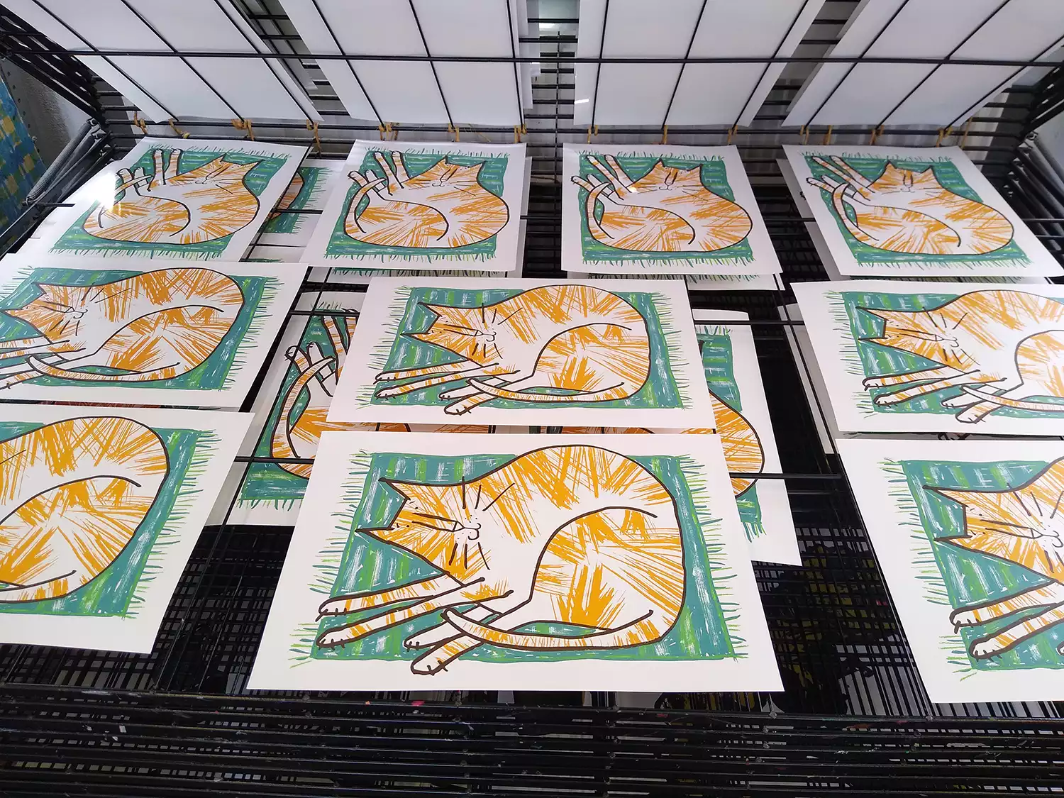 orange tabby cat screen prints drying