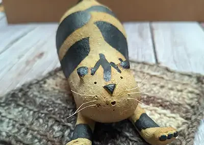 ceramic cat stretching